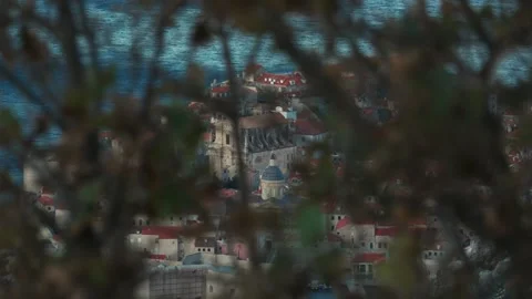 View of Dubrovnik city through branches in coastal Croatia during sunset or Stock Footage 313731561