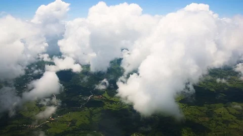 View of the earth and clouds from the window of the airplane. Stock Footage 80987789