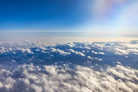 View of Earth and clouds from a window of the flying plane Stock Photos