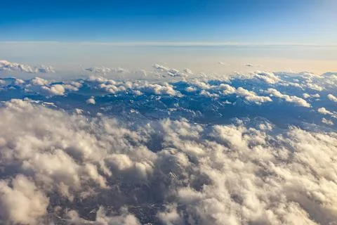 View of Earth and clouds from a window of the flying plane Stock Photos