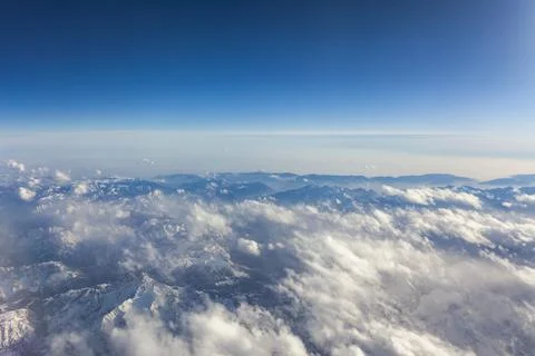 View of Earth and clouds from a window of the flying plane Stock Photos