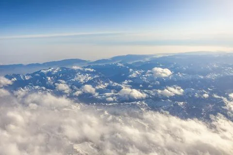 View of Earth and clouds from a window of the flying plane Stock Photos