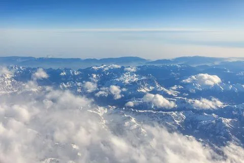 View of Earth and clouds from a window of the flying plane Stock Photos