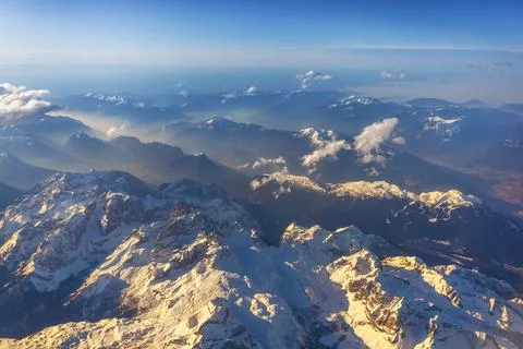 View of Earth and clouds from a window of the flying plane Stock Photos