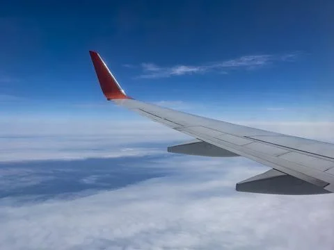 View of Earth and clouds from a window of the flying plane Stock Photos