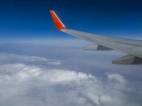 View of Earth and clouds from a window of the flying plane Stock Photos