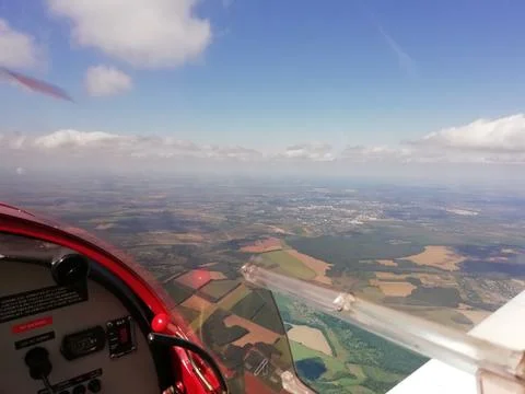 View of the earth, sky and clouds from the cockpit of a flying plane. Stock Photos