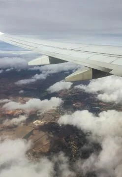 View of the earth from the window of an airplane with the wing Stock-Fotos