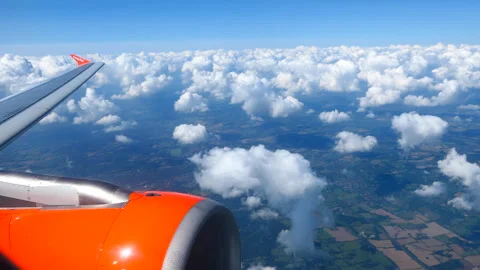 View of easyJet plane wing through window flying Stock Footage 244742046