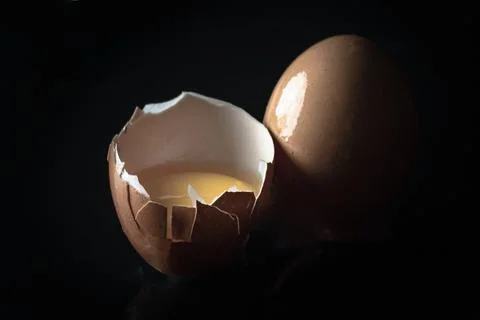 View of Egg yolk in Broken raw chicken eggshell and Fresh chicken egg (Hen .. Stock Photos