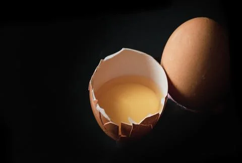 View of Egg yolk in Broken raw chicken eggshell and Fresh chicken egg (Hen .. Stock Photos
