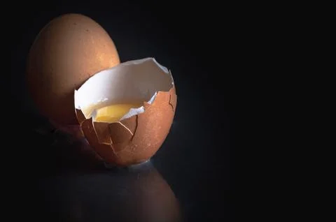 View of Egg yolk in Broken raw chicken eggshell and Fresh chicken egg (Hen .. Stock Photos