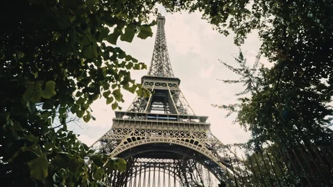 View of Eiffel Tower Behind Tree Green Foliage. Cinematic Dolly In Shot of Stock Footage 123121087