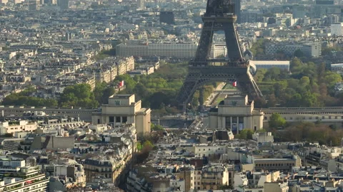 View of the Eiffel Tower in the center of Paris at sunset. A drone flies over a Stock Footage 228773646