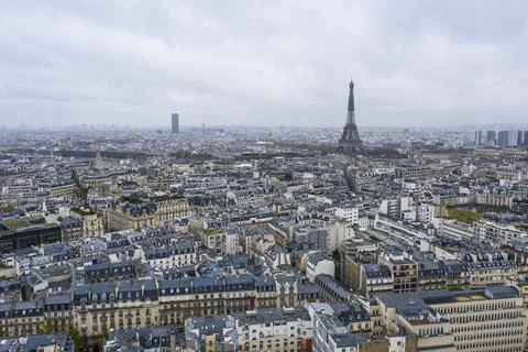 View on Eiffel tower over the roofs of Paris on a grey cloudy day Fotos Stock