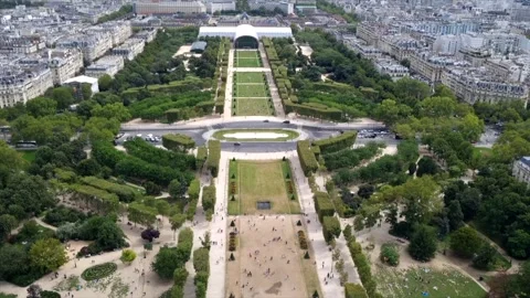 View from Eiffel Tower on Paris, cars passing, people resting on Champ de Mars Stock Footage 249832248