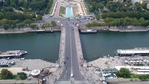 View from Eiffel Tower on Paris, cars passing, people walking on a bridge over Stock Footage 249832387