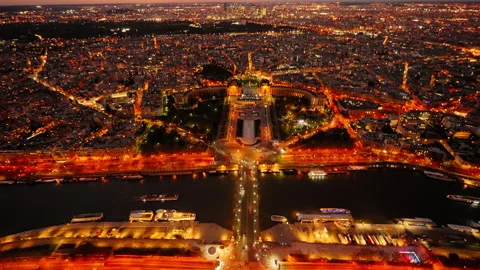 View from Eiffel Tower of Paris city illuminated at night with the Seine Stockbeeldmateriaal 244368497