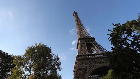 View of the Eiffel tower in Paris on a sunny summer day. Famous touristic places Stock Footage 74151466