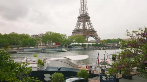 View of the Eiffel Tower from the right bank of the Seine River and motorboat. Stock Footage 310179029