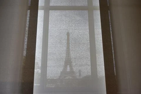 View on Eiffel tower through the curtains, Paris, France. Paris cityscape Foto stock