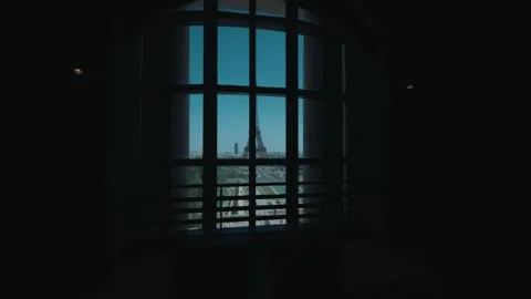 View of the Eiffel Tower through a large dark interior window, overlooking the Stock Footage 347833047