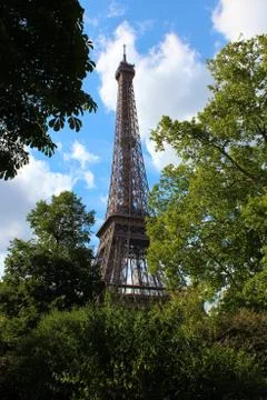 View on Eiffel tower under sunny summer sky Fotos Stock