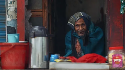 View of an elderly man smiling in a small shop in Bangladesh. Video stock 335550976