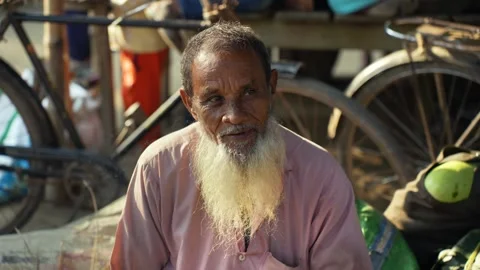 View of an elderly man smoking a cigarette in Bogura, Bangladesh. Stock Footage 334956959