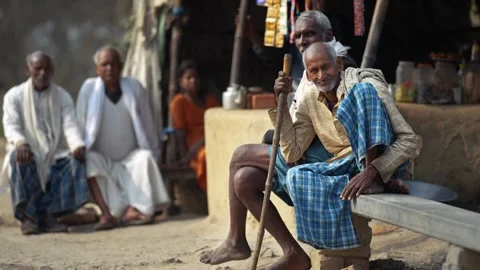 View of elderly men sitting outside a rural home in Patna, India. Video stock 335482800