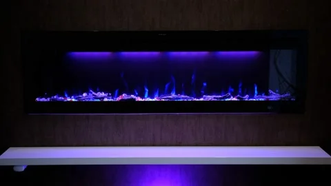View on electric fireplace with artificial sparkling flame, decor for the interi Stock Footage 182168325