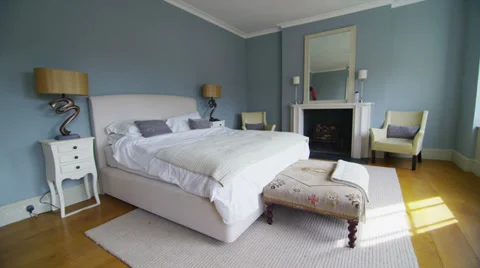 View of elegant bedroom in a stylish, classical home with a contemporary feel Stock Footage