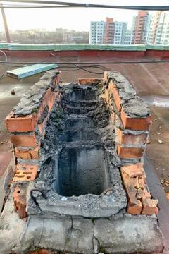 A view of the elements of the roof of a modern multi-storey brick building Stock Photos