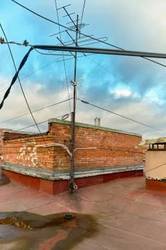 A view of the elements of the roof of a modern multi-storey brick building Stock Photos