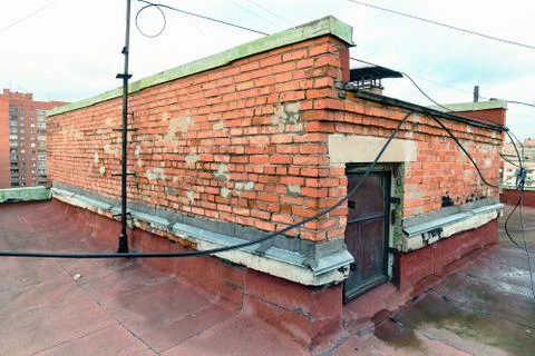 A view of the elements of the roof of a modern multi-storey brick building Stock Photos