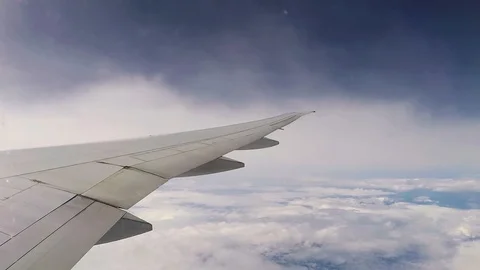 View from the eluminator on the wing of an airplane and flying clouds Stock Footage 127530813