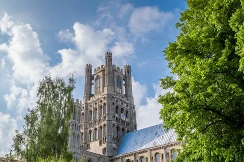 View of the Ely Cathedral against a blue sky with partial clouds Stock Photos