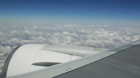 View elyuminatory flying a passenger plane over the mountains in the clouds Stock-Footage 63462995
