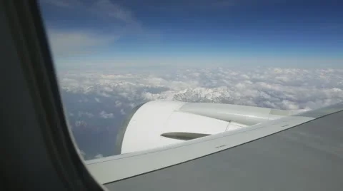 View elyuminatory flying a passenger plane over the mountains in the clouds Stock Footage 63463733