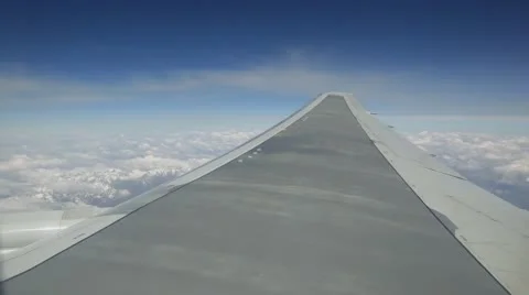 View elyuminatory flying a passenger plane over the mountains in the clouds Stock Footage 63464336