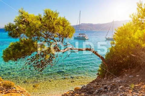 View of an emerald and transparent mediterranean sea with yachts.. Stock Photos