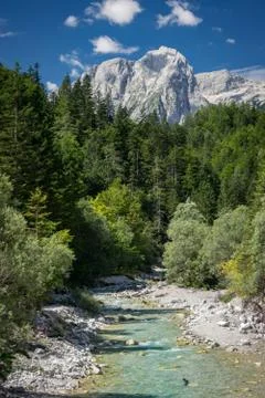 View of emerald or turquoise colored river and Triglav mountain in Slovenia Stock Photos