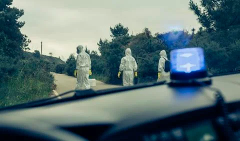 View from emergency car of people with bacteriological protection suits Stock Photos