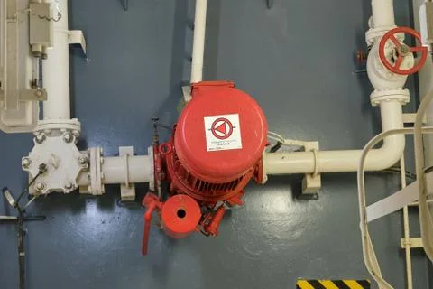 View of emergency fire pump on board of cargo ship Stock Photos