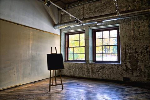 View of an empty art studio with painting on an easel Stock Photos