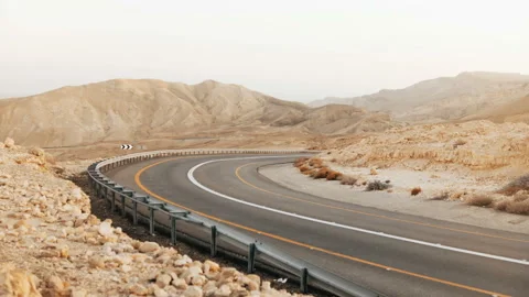 View of empty asphalt road curve in Israel desert. 4K. Roadway in ancient Negev Stock Footage 86895781