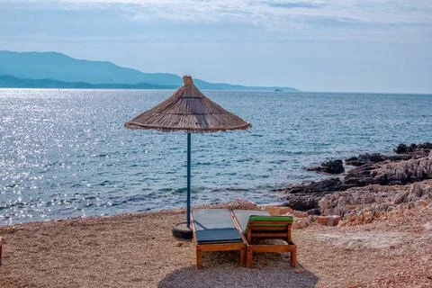 View of empty beach - sun beds and umbrella Stock Photos