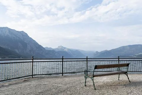 View of an empty bench on a gloomy cloudy day that stands on the embankment of a Stock Photos