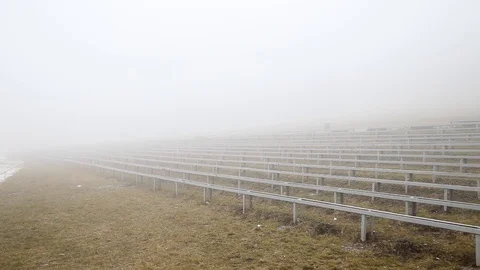 View of the empty benches in front of the stage in a very strong fog in autumn Stock Footage 122705105