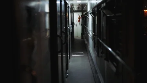 View of the empty corridor of the train standing at the railway station. Scary Stock Footage 104644888